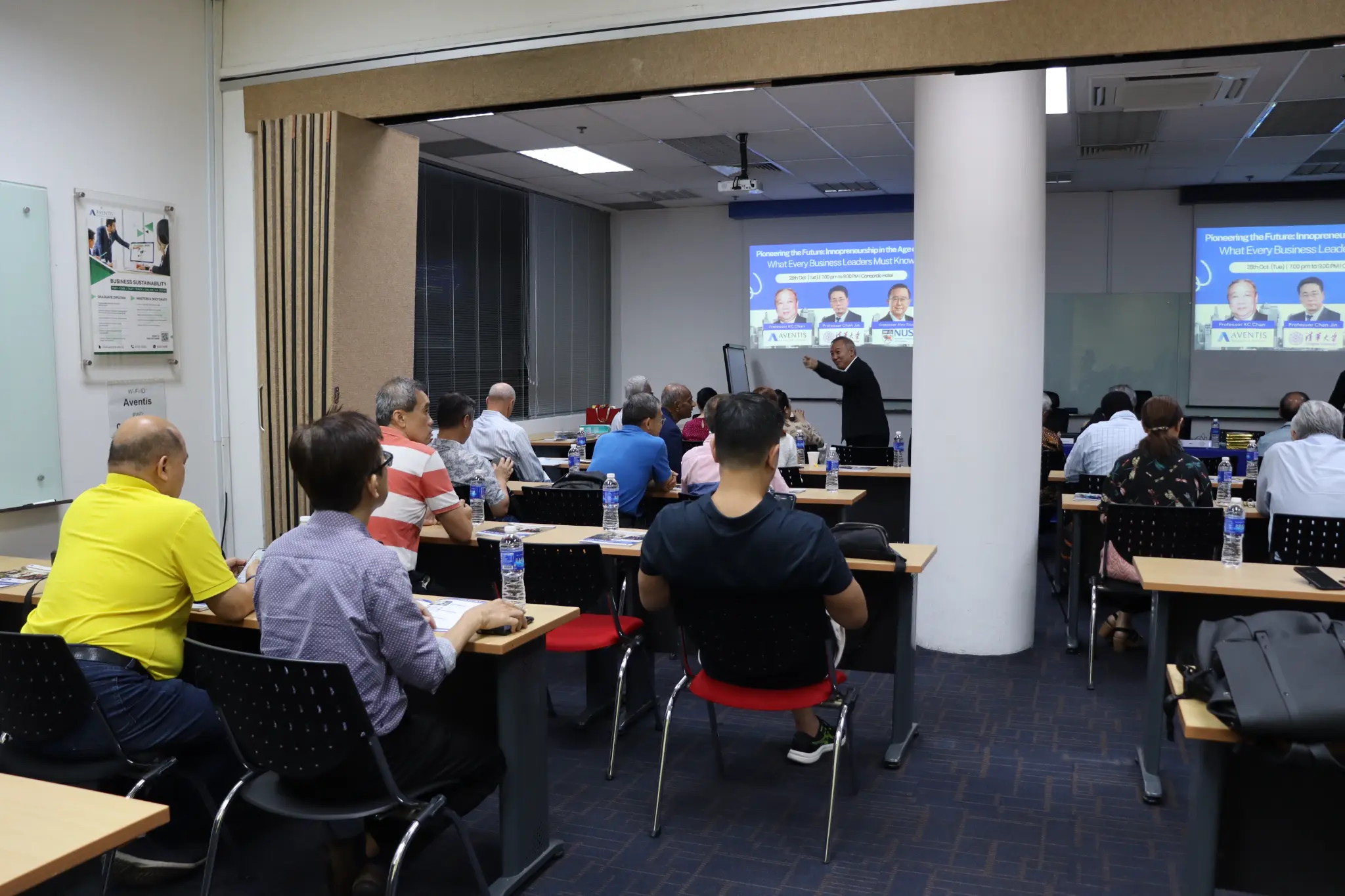 Working professionals engaging in knowledge-sharing and continuous learning at an Aventis Graduate School event.